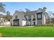 Stunning two-story home featuring a modern farmhouse design, manicured lawn, and sophisticated landscaping at 208 Green Lake Dr., Myrtle Beach, SC 29572