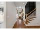 Bright foyer boasts wood floors, staircase, and stylish decor, creating a welcoming entrance at 208 Green Lake Dr., Myrtle Beach, SC 29572