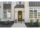 Inviting front entrance showcasing a wood door, brick facade, rain chain, and manicured landscaping at 208 Green Lake Dr., Myrtle Beach, SC 29572