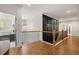 Hallway features decorative black paneling, wooden banister, and elegant light fixture at 208 Green Lake Dr., Myrtle Beach, SC 29572