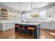 Bright kitchen featuring a large island with bar seating, white cabinets, and modern pendant lighting at 208 Green Lake Dr., Myrtle Beach, SC 29572
