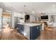 Open-concept kitchen featuring an island with bar seating, stainless appliances, and seamless living area access at 208 Green Lake Dr., Myrtle Beach, SC 29572