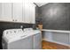 Well-equipped laundry room featuring sleek cabinets, modern washer and dryer at 208 Green Lake Dr., Myrtle Beach, SC 29572