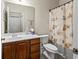 Cozy bathroom featuring wood vanity, neutral walls, and decorative seashell shower curtain at 220 Portsmith Dr. # 2, Myrtle Beach, SC 29588