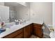 Bathroom features a large mirror, spacious white countertop and stained wood cabinets at 220 Portsmith Dr. # 2, Myrtle Beach, SC 29588