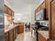 View of kitchen with wood cabinets, stainless steel microwave, and view into the dining area at 220 Portsmith Dr. # 2, Myrtle Beach, SC 29588