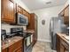 View of kitchen with stainless steel oven and microwave, wood cabinets, and neutral countertop at 220 Portsmith Dr. # 2, Myrtle Beach, SC 29588