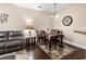 Living room with dark hardwood floors, grey sofa and dining area at 220 Portsmith Dr. # 2, Myrtle Beach, SC 29588