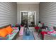 The porch is furnished with wicker seating and a rug at 220 Portsmith Dr. # 2, Myrtle Beach, SC 29588