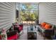Relaxing screened-in porch filled with comfortable wicker furniture and vibrant pillows at 220 Portsmith Dr. # 2, Myrtle Beach, SC 29588