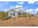Stylish home with a backyard patio covered by a bright pergola, surrounded by greenery at 223 Obi Lane, Surfside Beach, SC 29575