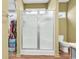 Enclosed glass shower, toilet, and walk-in closet in a well-lit bathroom at 223 Obi Lane, Surfside Beach, SC 29575