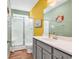 Well-lit bathroom featuring a glass shower, gray vanity, and beach-themed decor at 223 Obi Lane, Surfside Beach, SC 29575