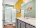 Well-lit bathroom featuring a glass shower, gray vanity, and beach-themed decor at 223 Obi Lane, Surfside Beach, SC 29575