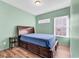 Bedroom with a wooden bed, storage drawers, and an adjacent small bedside table at 223 Obi Lane, Surfside Beach, SC 29575