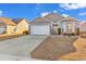Charming single-Gathering home featuring a well-manicured lawn, a two-car garage, and inviting curb appeal at 223 Obi Lane, Surfside Beach, SC 29575
