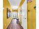 Bright hallway featuring hardwood floors, yellow walls, and decorative beach themed decor at 223 Obi Lane, Surfside Beach, SC 29575