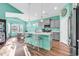 Open kitchen with island, stainless steel appliances, gray cabinets, and hardwood floors at 223 Obi Lane, Surfside Beach, SC 29575