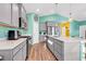 Spacious kitchen with gray cabinets, quartz countertops and stainless steel appliances at 223 Obi Lane, Surfside Beach, SC 29575