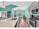 A kitchen with a view into a dining area with high ceilings and natural light at 223 Obi Lane, Surfside Beach, SC 29575