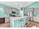 Well lit kitchen showcasing a center island, stainless steel appliances and gray cabinets at 223 Obi Lane, Surfside Beach, SC 29575