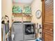 Convenient laundry room featuring stainless steel washer and dryer with ample storage space at 223 Obi Lane, Surfside Beach, SC 29575