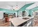 Open-concept living space with a spacious island, vaulted ceilings, and ample natural light at 223 Obi Lane, Surfside Beach, SC 29575