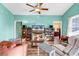 Bright living room with ceiling fan, TV, and wood-look flooring provides a relaxing atmosphere at 223 Obi Lane, Surfside Beach, SC 29575