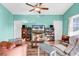 Cozy living room features a ceiling fan and two decorative cabinets next to the TV at 223 Obi Lane, Surfside Beach, SC 29575