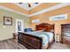 Spacious main bedroom featuring a large bed, wood-look flooring, and large windows at 223 Obi Lane, Surfside Beach, SC 29575
