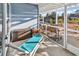 Serene screened porch with stylish chaise lounge and outdoor furniture, overlooking lush landscape at 223 Obi Lane, Surfside Beach, SC 29575