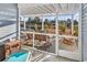 Inviting screened porch with comfortable seating, perfect for enjoying peaceful outdoor living at 223 Obi Lane, Surfside Beach, SC 29575