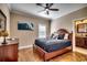 Bedroom features hardwood floors, a ceiling fan, and an ensuite bathroom at 232 Wahee Pl., Conway, SC 29527