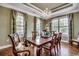 Formal dining room featuring hardwood floors, a chandelier, and large windows with custom curtains at 232 Wahee Pl., Conway, SC 29527