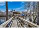 Picturesque waterfront dock featuring a covered boat lift and seating area, perfect for relaxing by the water at 232 Wahee Pl., Conway, SC 29527