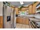 Bright kitchen featuring stainless steel appliances, wood cabinets, and a scenic view from the window at 232 Wahee Pl., Conway, SC 29527