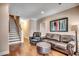 Open living room with hardwood floors, comfortable seating, and stairs at 232 Wahee Pl., Conway, SC 29527