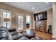 Relax in this living room with a plush leather sofa and plantation shutters at 232 Wahee Pl., Conway, SC 29527