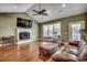 Cozy living room with a fireplace, hardwood floors, and large windows at 232 Wahee Pl., Conway, SC 29527