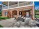 A covered outdoor brick patio featuring an outdoor dining set and exercise equipment at 232 Wahee Pl., Conway, SC 29527