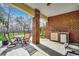 A covered patio featuring a brick wall, outdoor dining set, and outdoor kitchen at 232 Wahee Pl., Conway, SC 29527
