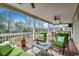 A wide porch with green seating, ceiling fans, and a grill with dining table at 232 Wahee Pl., Conway, SC 29527