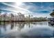 Scenic waterfront view showcasing calm waters, lush treeline, and a covered boat dock at 232 Wahee Pl., Conway, SC 29527