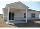 Back porch features an open layout and sliding glass doors that add natural light at 263 Warner Crossing Way, Loris, SC 29569