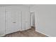 Spacious bedroom showcasing wood flooring and a double door closet at 263 Warner Crossing Way, Loris, SC 29569