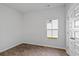 A light-filled bedroom with wood flooring and a window overlooking the yard at 263 Warner Crossing Way, Loris, SC 29569