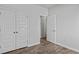 A cozy bedroom features wood flooring, a double door closet, and an entry door at 263 Warner Crossing Way, Loris, SC 29569