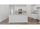 Well-lit kitchen with white cabinetry, an island, and stainless steel appliances at 263 Warner Crossing Way, Loris, SC 29569