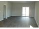 Bright living room with sliding glass doors and modern hardwood floors at 263 Warner Crossing Way, Loris, SC 29569