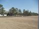 Spacious lot with mature trees along property line at 263 Warner Crossing Way, Loris, SC 29569